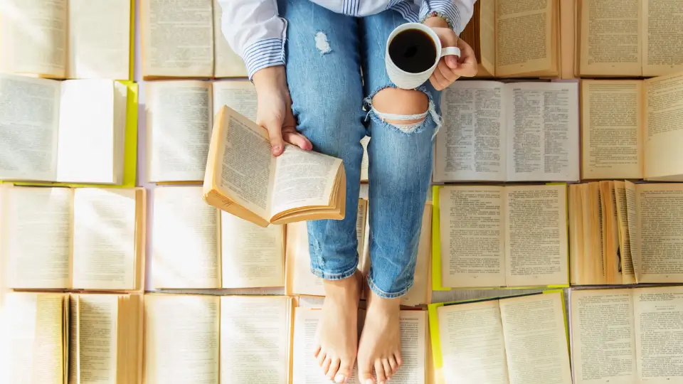 Sitting on Books Reading with a Coffee